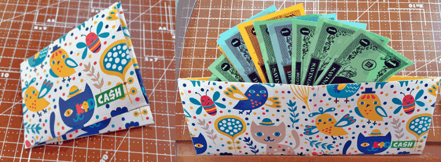 A folded KidCash wallet with a cat pattern